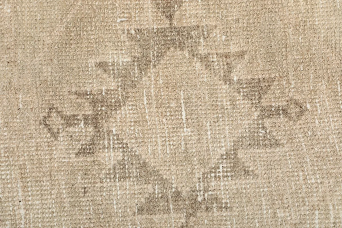 Macro shot of the low wool pile, revealing the natural fibers and subtle color shifts.