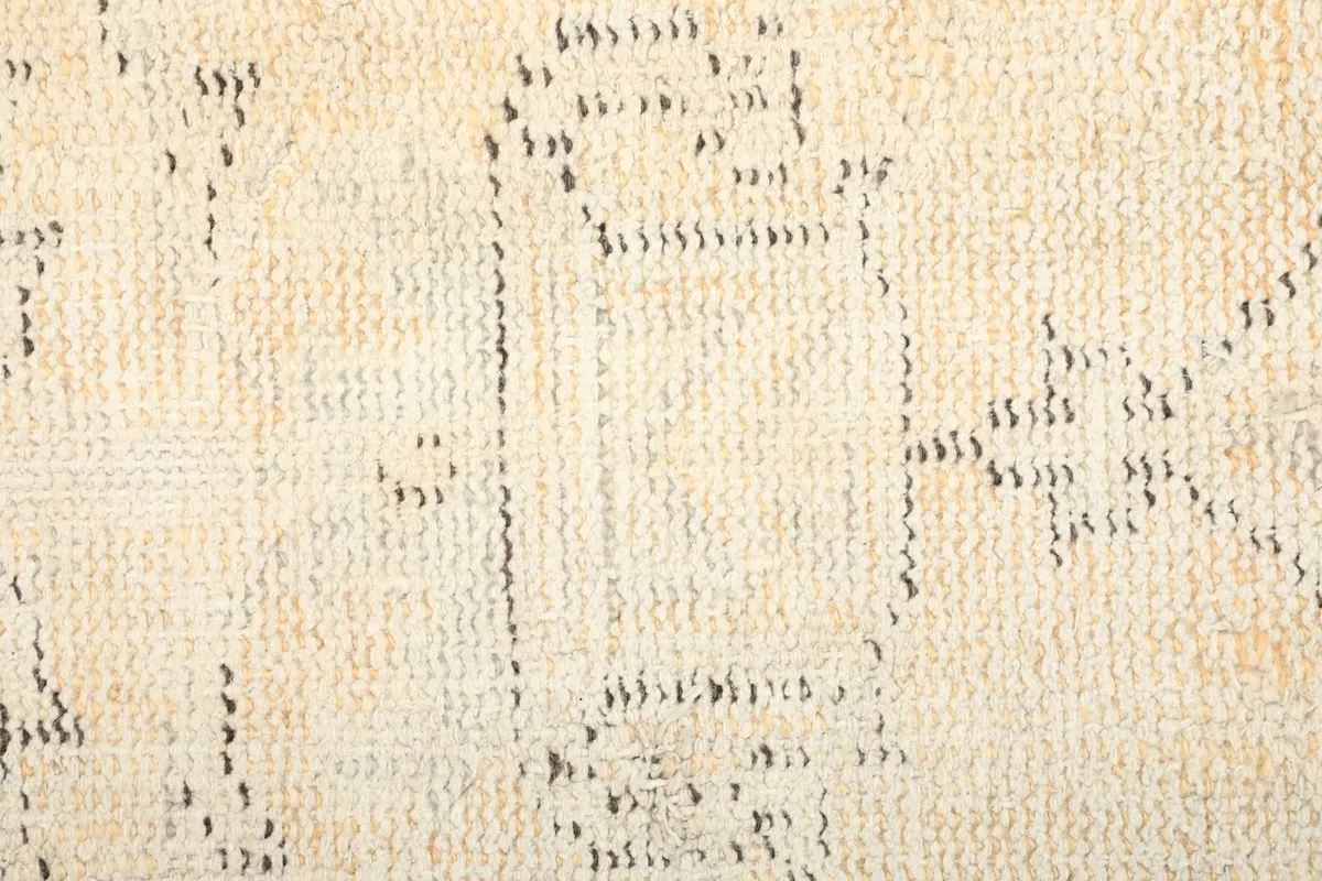 Texture detail showing the low pile and hand-knotted wool construction of the rug