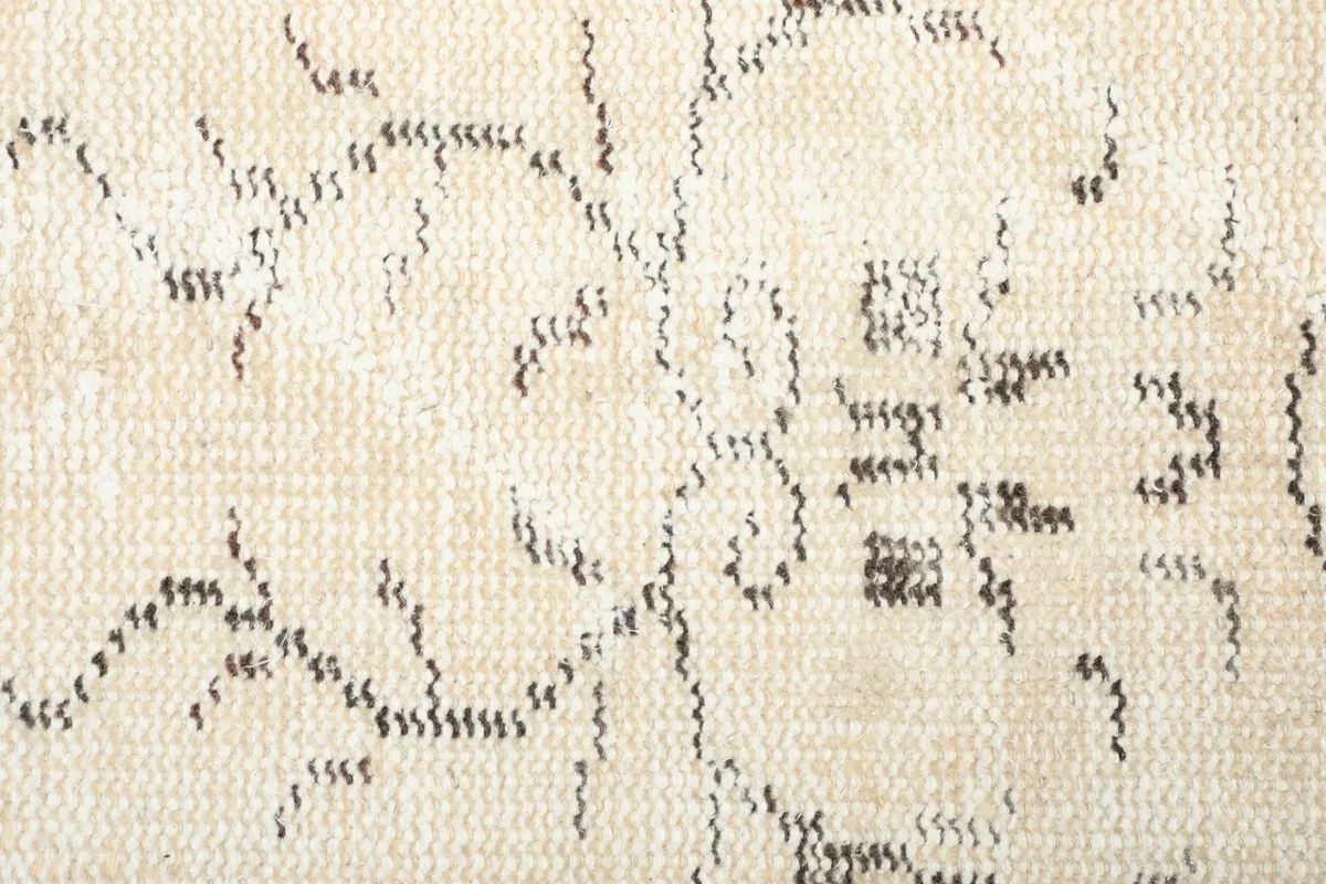 Close-up view of the low wool pile texture and the hand-knotted construction of the rug