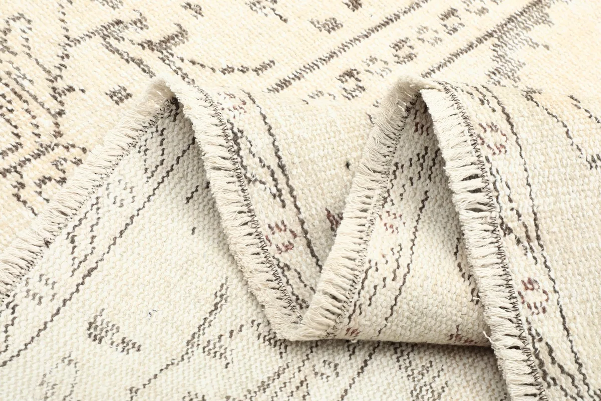 Another folded section of the vintage rug, showing the flexibility and texture of the material