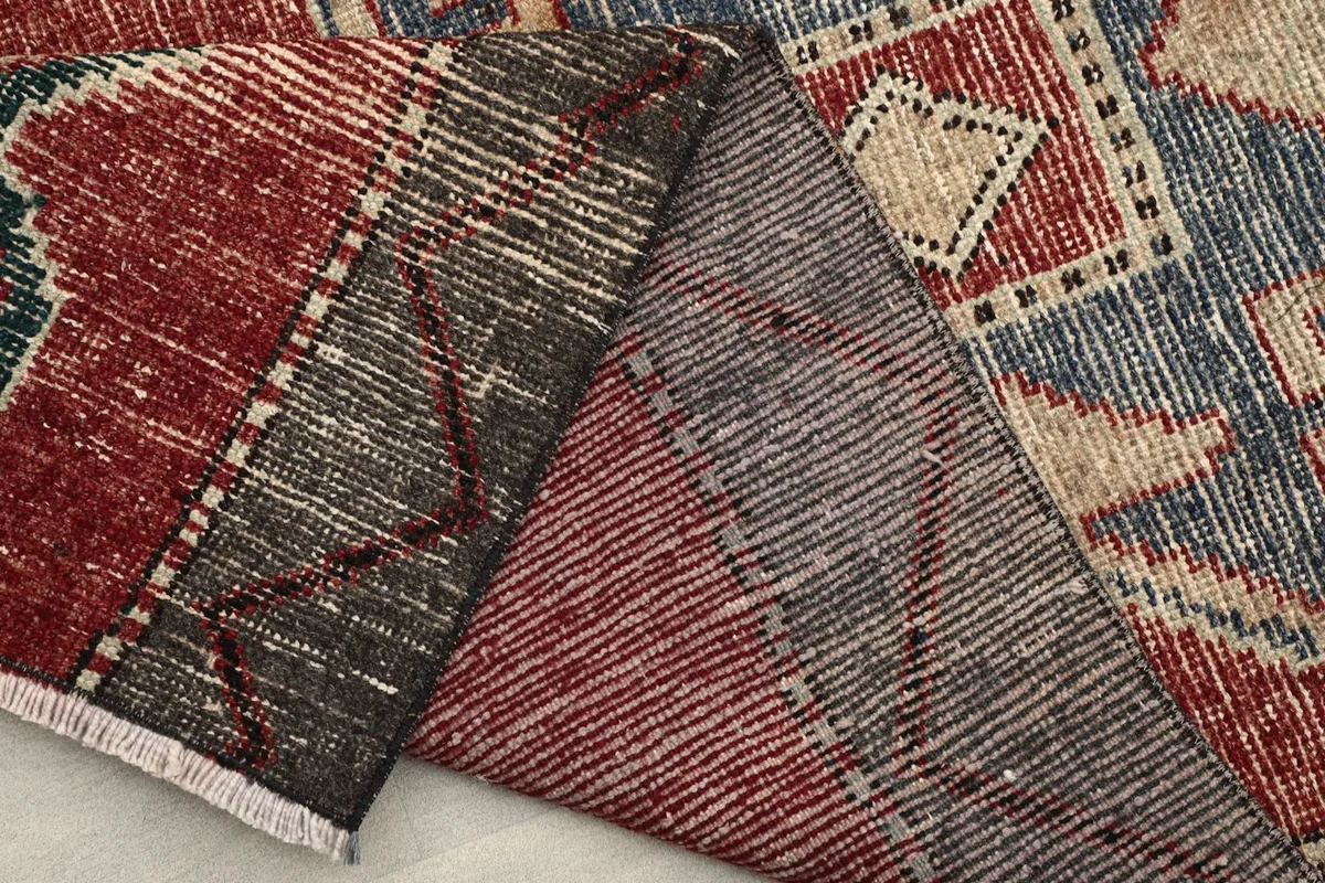 View of the reverse side of the runner rug, illustrating the hand-knotted construction.