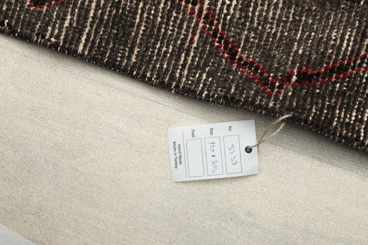 Close-up of the rug's tag, indicating its origin and dimensions.