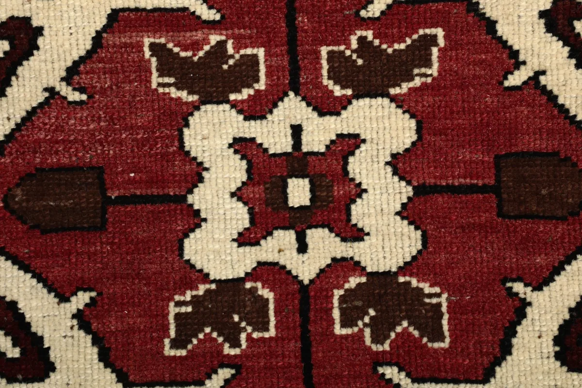 Detailed view of the hand-knotted wool pile and intricate geometric weaving