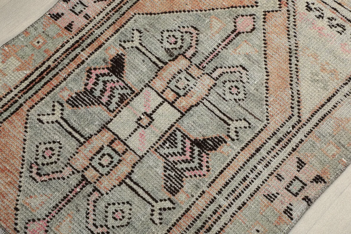 Detailed angled view of the intricate geometric patterns and color variations in the rug's pile.