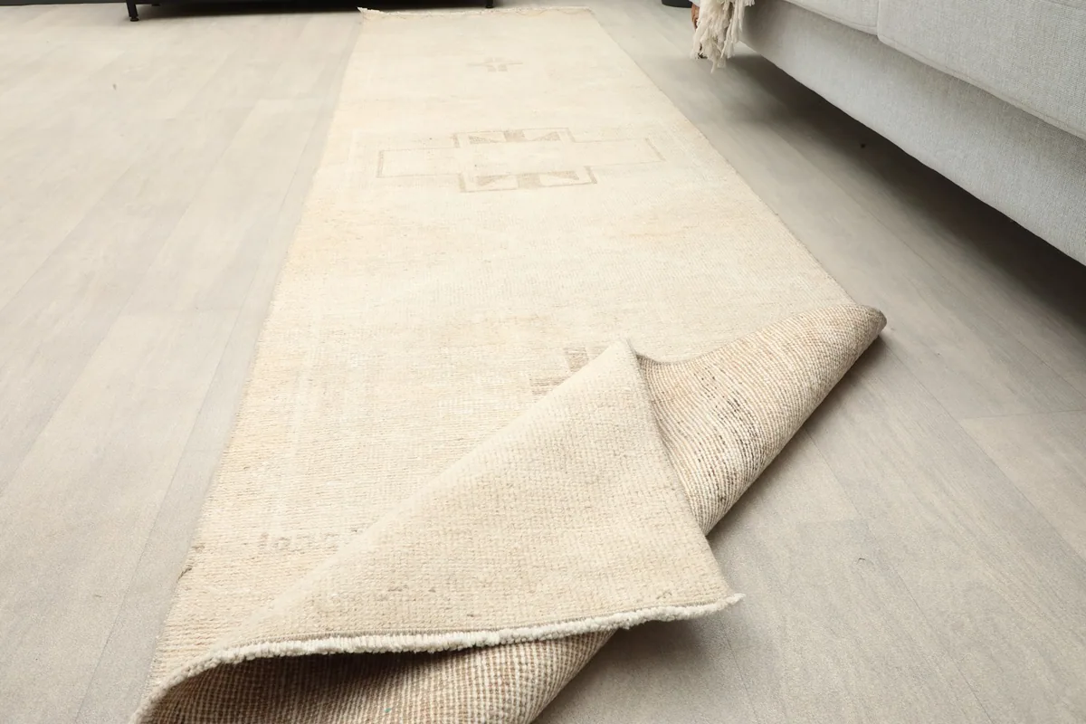 Runner partially folded, showing the flexibility and thickness of the vintage wool rug