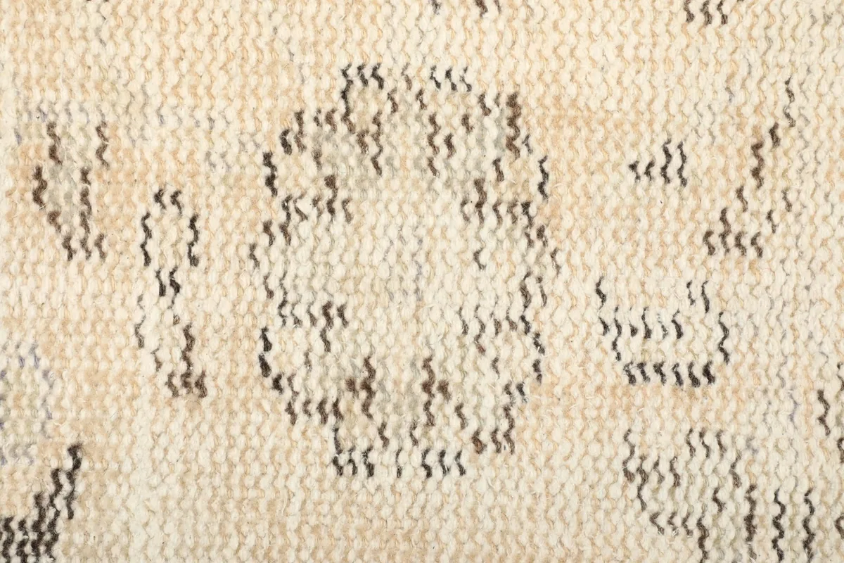 Close-up of the back of the hand-knotted rug, revealing the intricate knotting and foundation