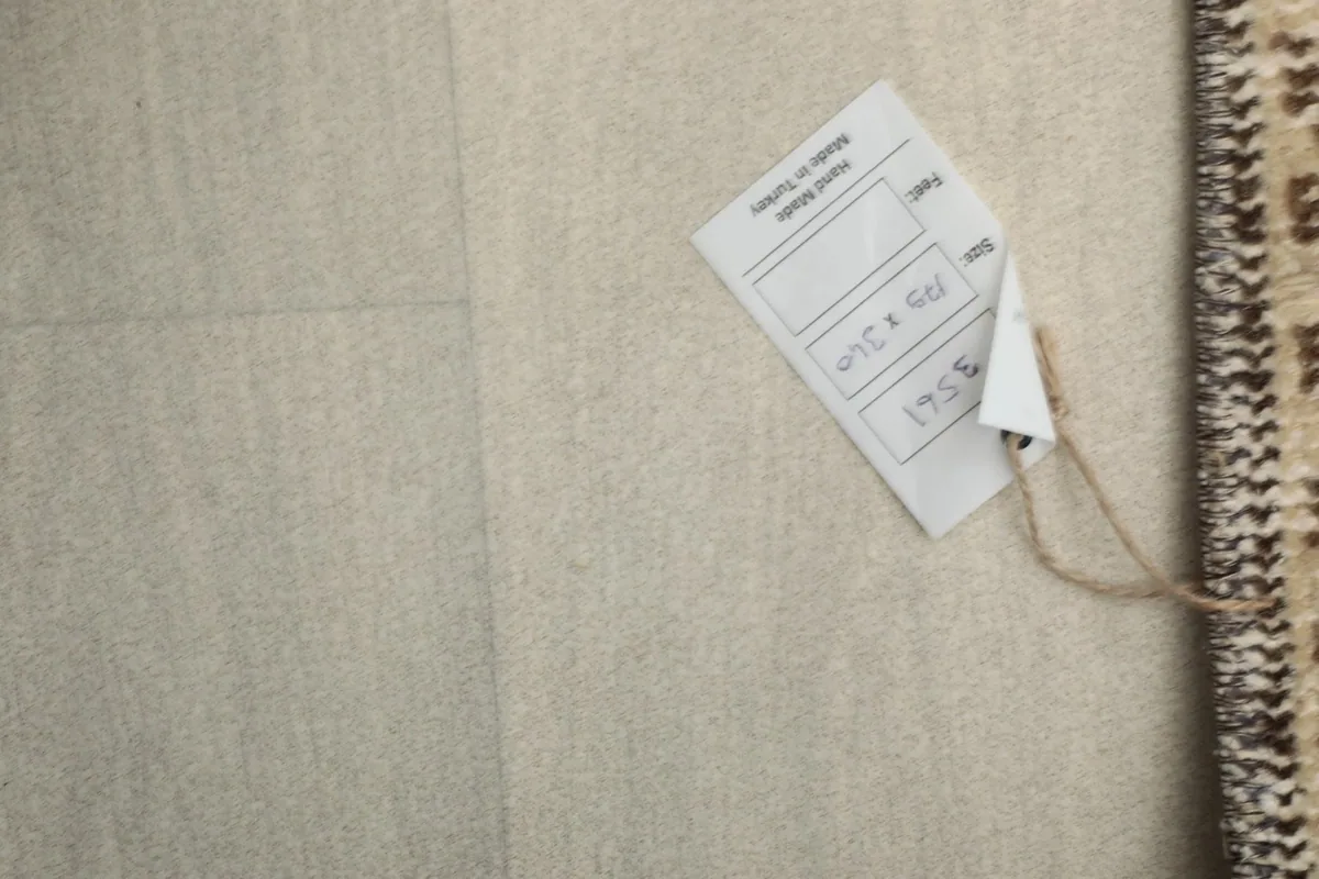 Product tag attached to the rug, showing size and origin information