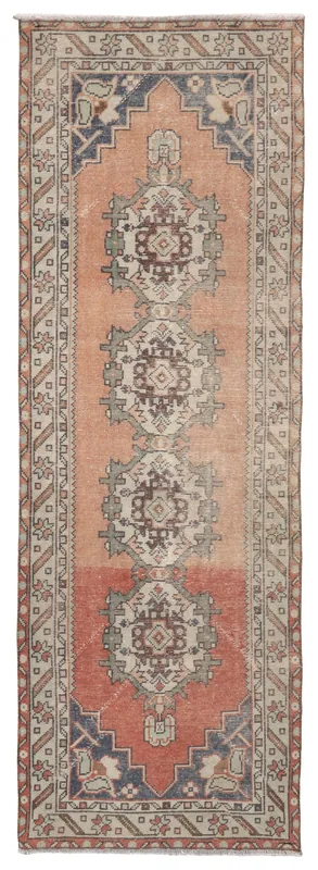 Full overhead view of the rust and beige geometric Anatolian runner rug on a white background.