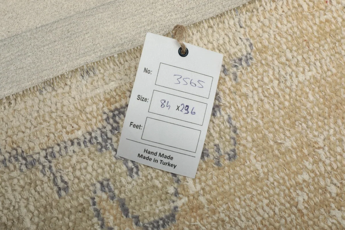 Tag showing the rug's dimensions and 'Hand Made Made in Turkey' on the reverse side.