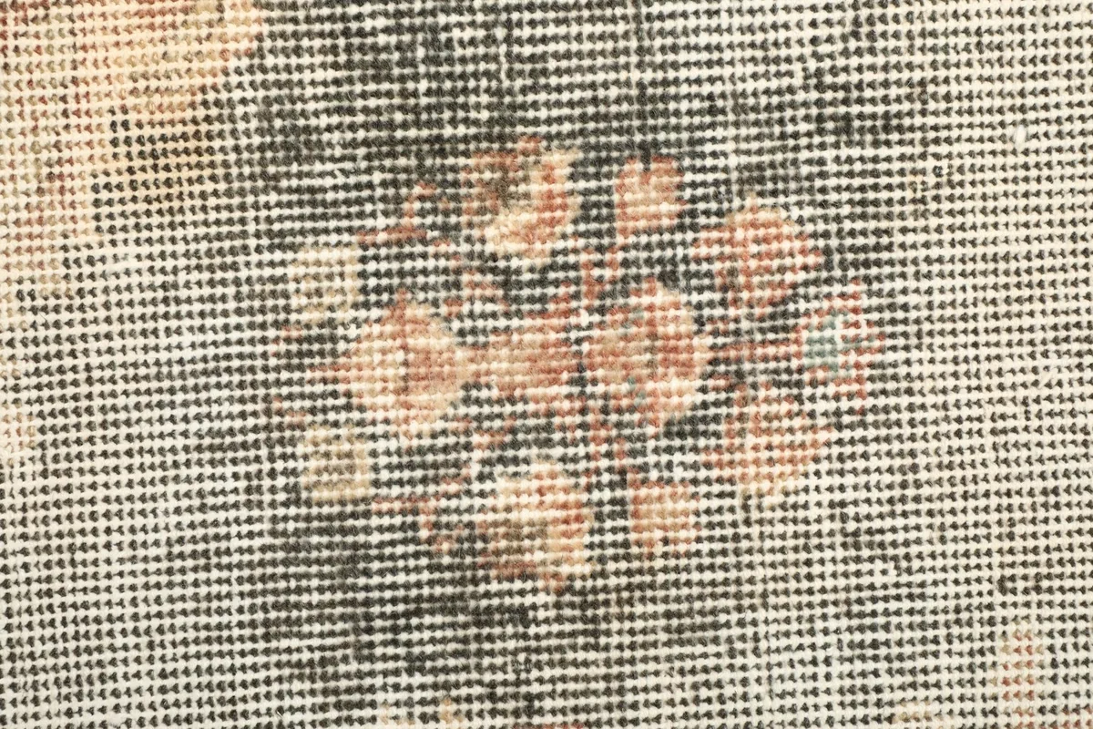 Close-up of the low wool pile, showing the texture and hand-knotted construction of the rug.