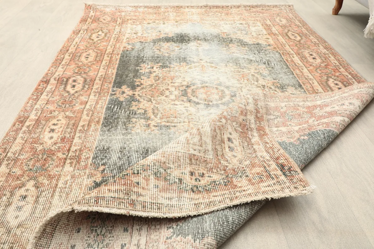 The rug partially folded, displaying its flexibility and the consistent pattern from the top to the underside.