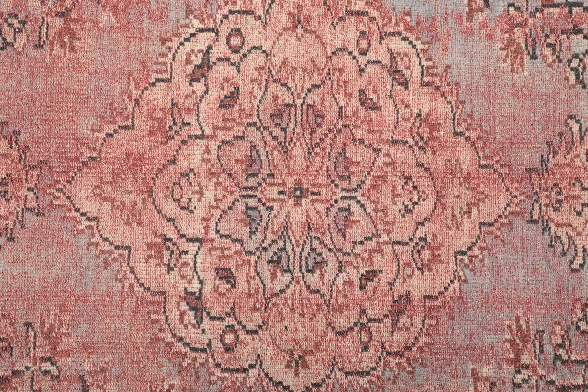 Detailed view of the central medallion motif with rose and charcoal patterns