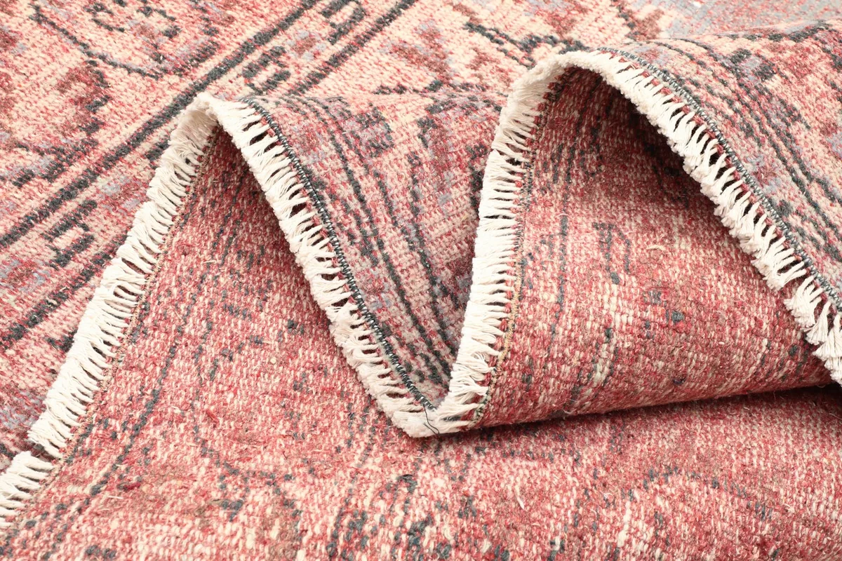 View of the rug's backside, revealing the hand-knotted cotton foundation