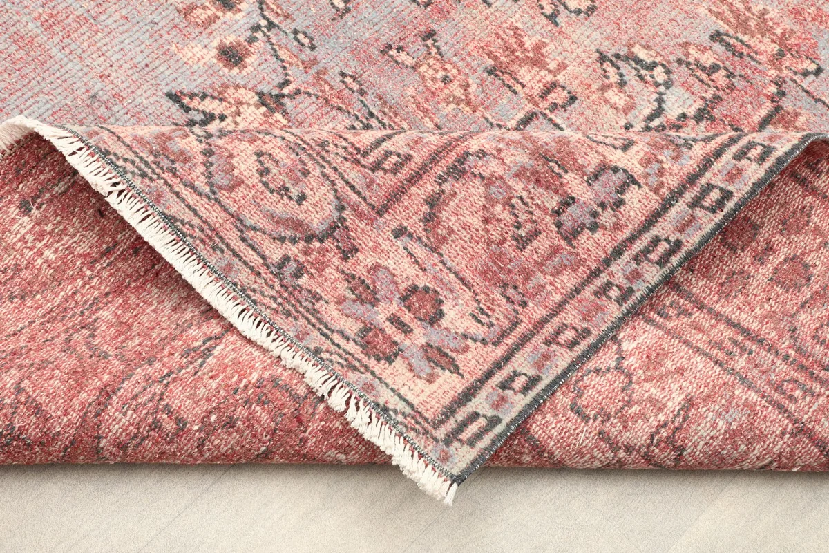 Folded corner of the rug showing its thickness and the reverse side