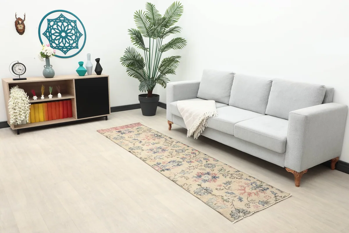 Long shot of the cream runner in a living space with a sofa and side cabinet