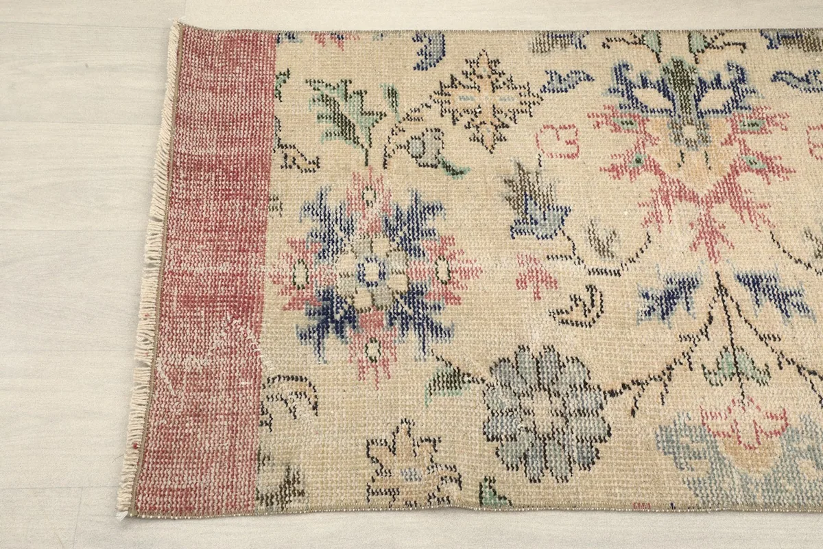 Detail showing the faded rose end of the runner with its floral motifs