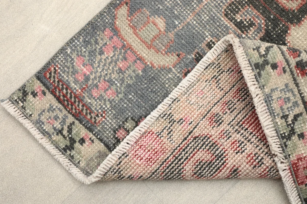 View of the rug folded, revealing the wool pile and cotton foundation from the back