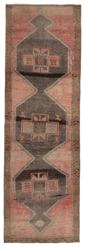 Full overhead view of the rose and charcoal geometric Anatolian runner rug on a white background