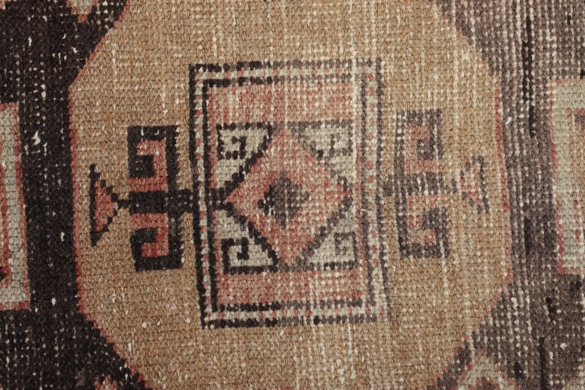 Close-up of the rug's pile, revealing the hand-knotted wool texture and color variations.