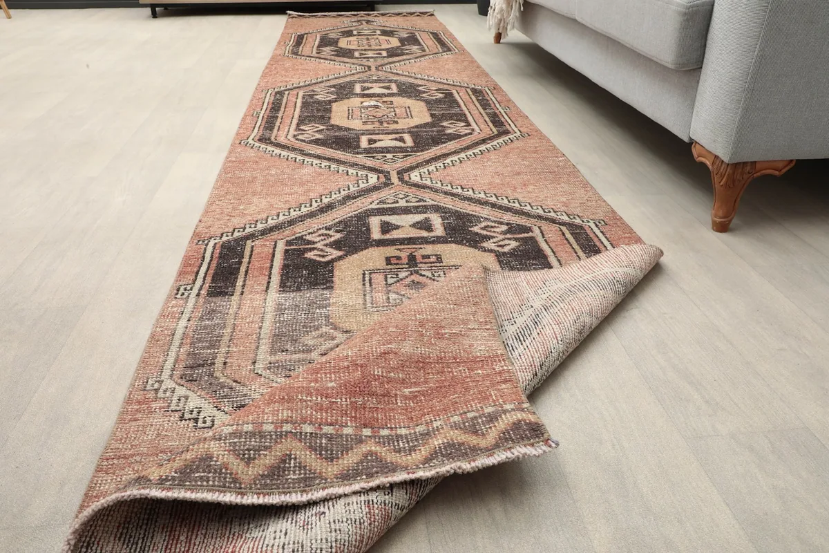 Runner rug partially folded, showing the flexibility and construction from an angle.