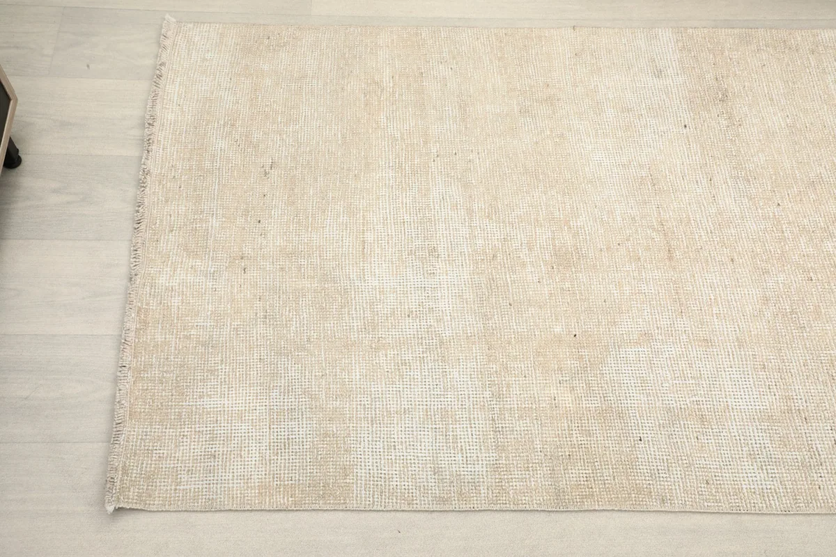 Close-up angled view of the other end of the beige runner, highlighting its clean finish.