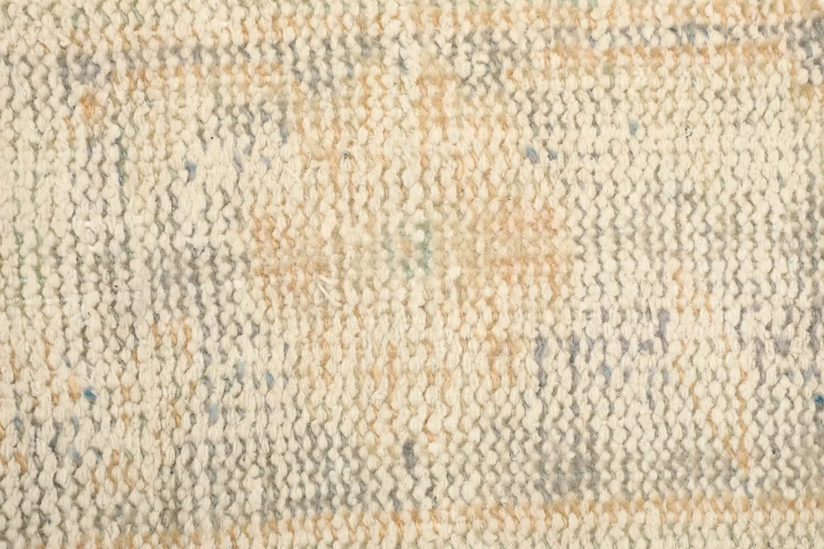 Texture of the hand-knotted wool pile, revealing the subtle color shifts and weave