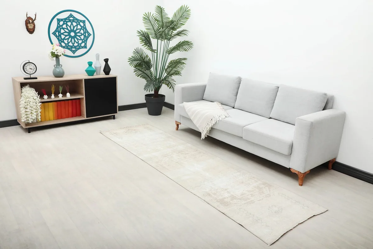 Overhead view of the Anatolian runner rug in a room setting, highlighting its scale and light colors.