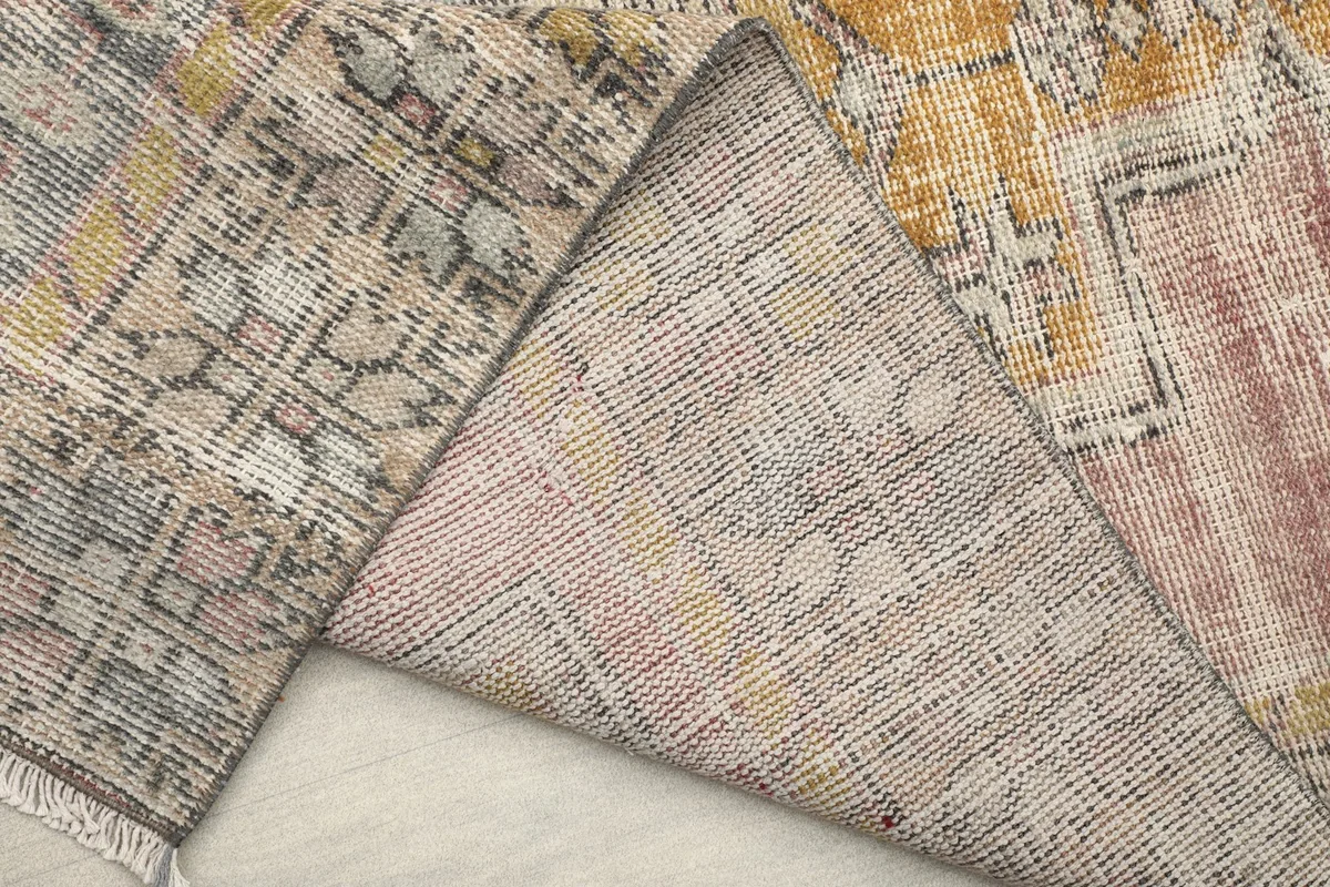 Underside view of the rug, showing the reverse of the hand-knotted construction and cotton foundation.
