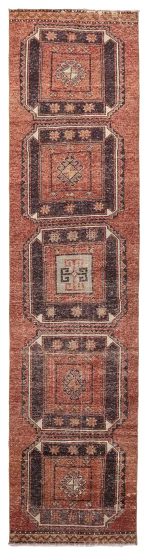 Full overhead view of the rust and navy geometric runner rug.
