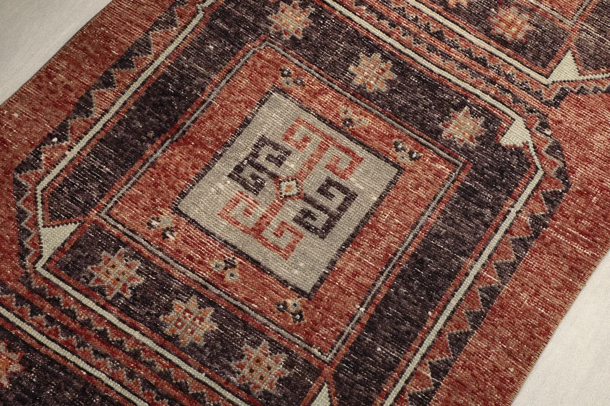 Close-up of a central geometric motif within a navy square.