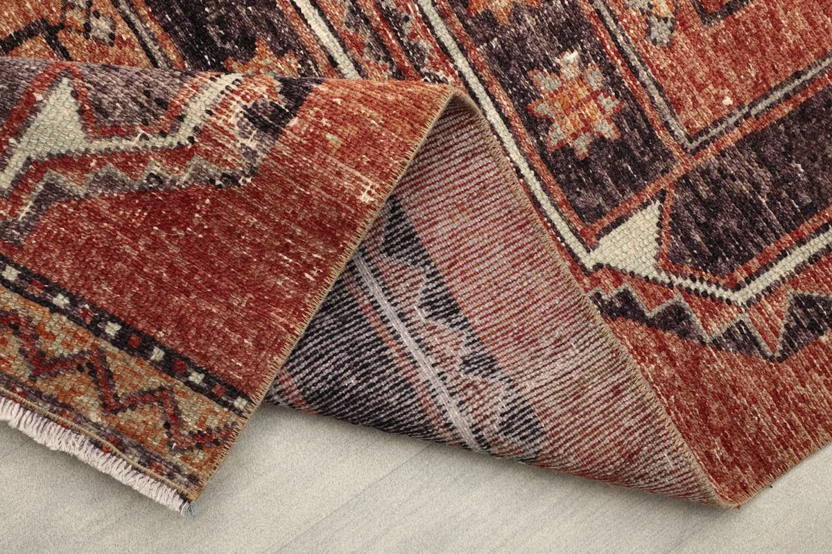 Folded section of the rug revealing the construction and reverse patterns.