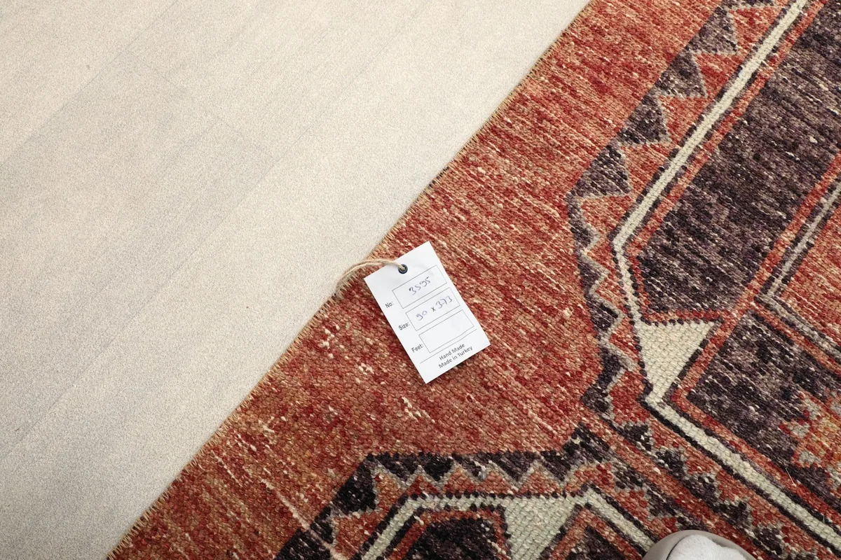Corner of the rug with the product tag, showing the texture of the pile.