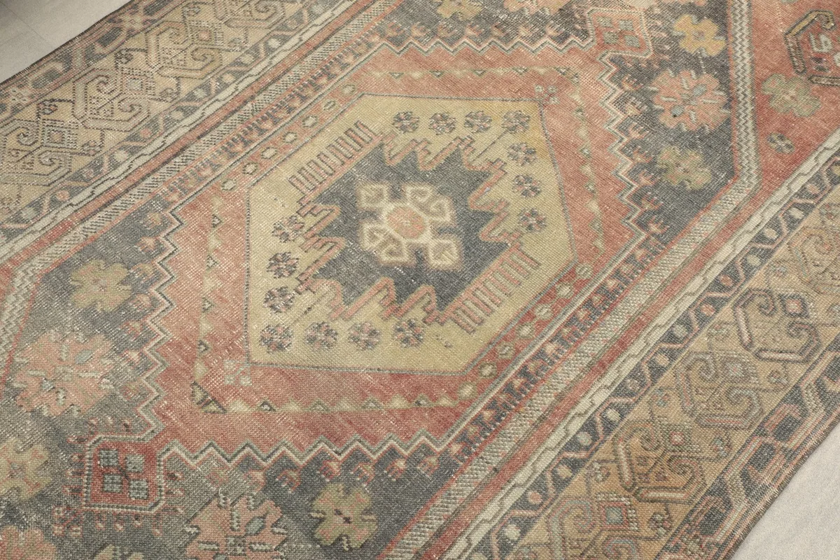 Detailed view of the central gray medallion with beige and charcoal accents
