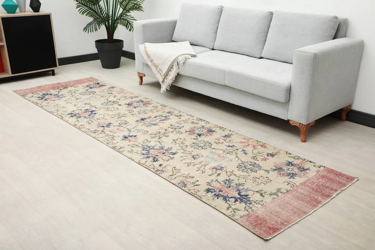 Close-up room view of the runner rug showing its length and placement next to a sofa.