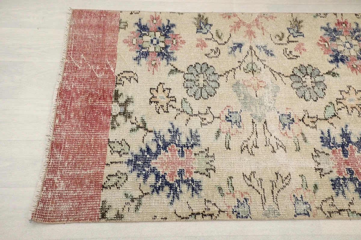 Another detail shot of the rug's floral design and the distressed rose border.