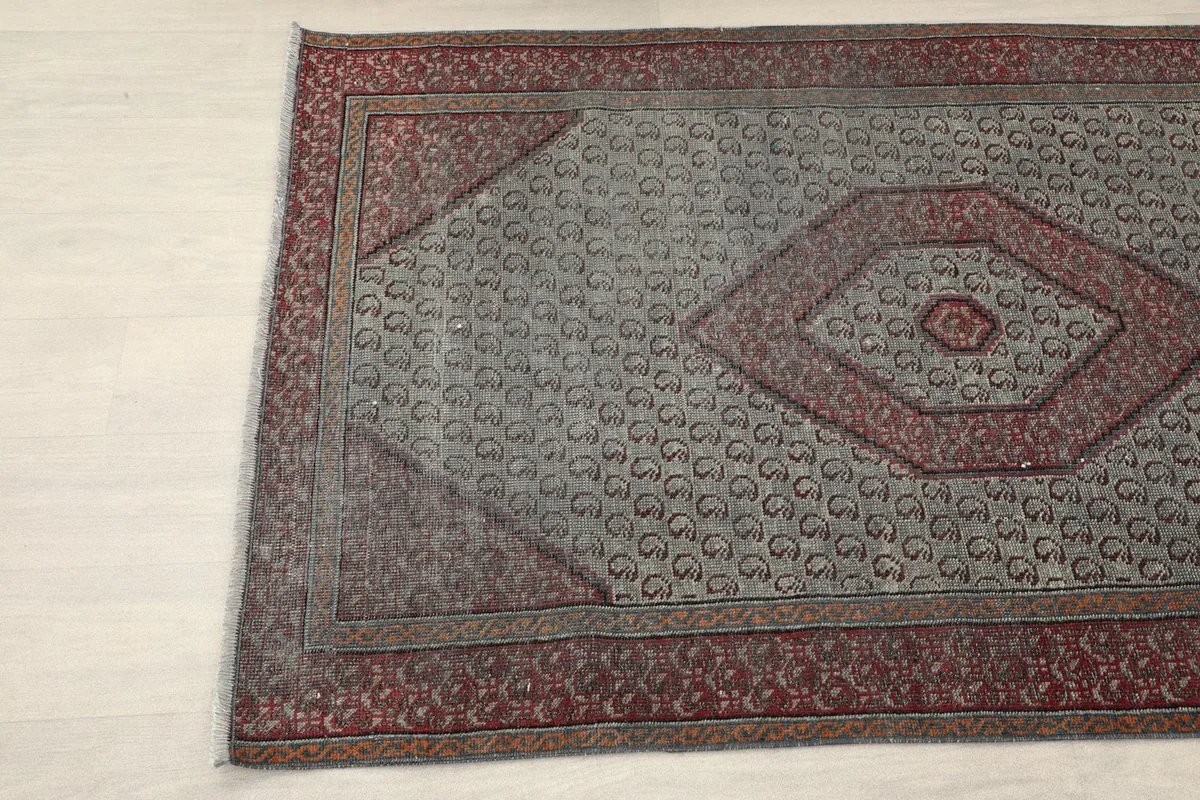 Angled view highlighting the central rust medallion and surrounding gray motifs