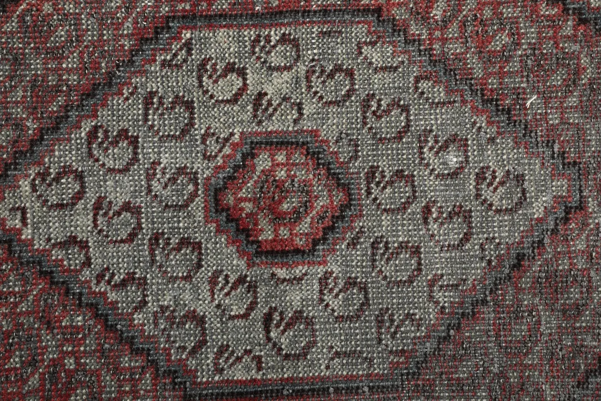 Close-up of the central medallion showing the wool pile texture and color variations