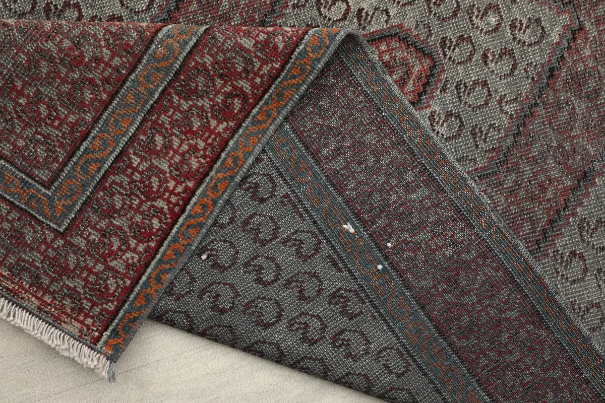 Underside of the rug showing the hand-knotted cotton foundation and wool knots