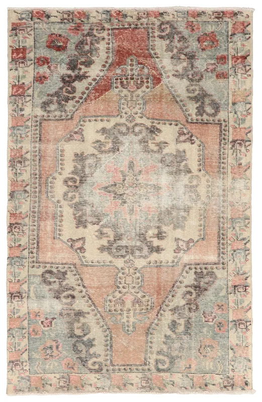 Full overhead view of the vintage Anatolian rug with an ivory field and tribal medallion design