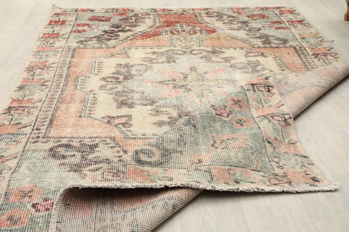 Partial view of the rug's reverse side, revealing the hand-knotted construction and the even pile
