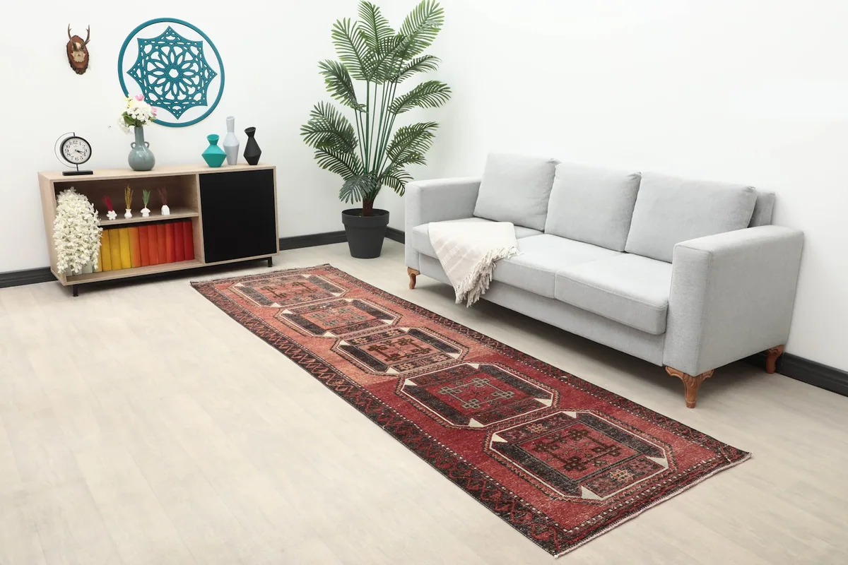 Wide view of the vintage Anatolian runner in a modern living space with a sofa and decor.
