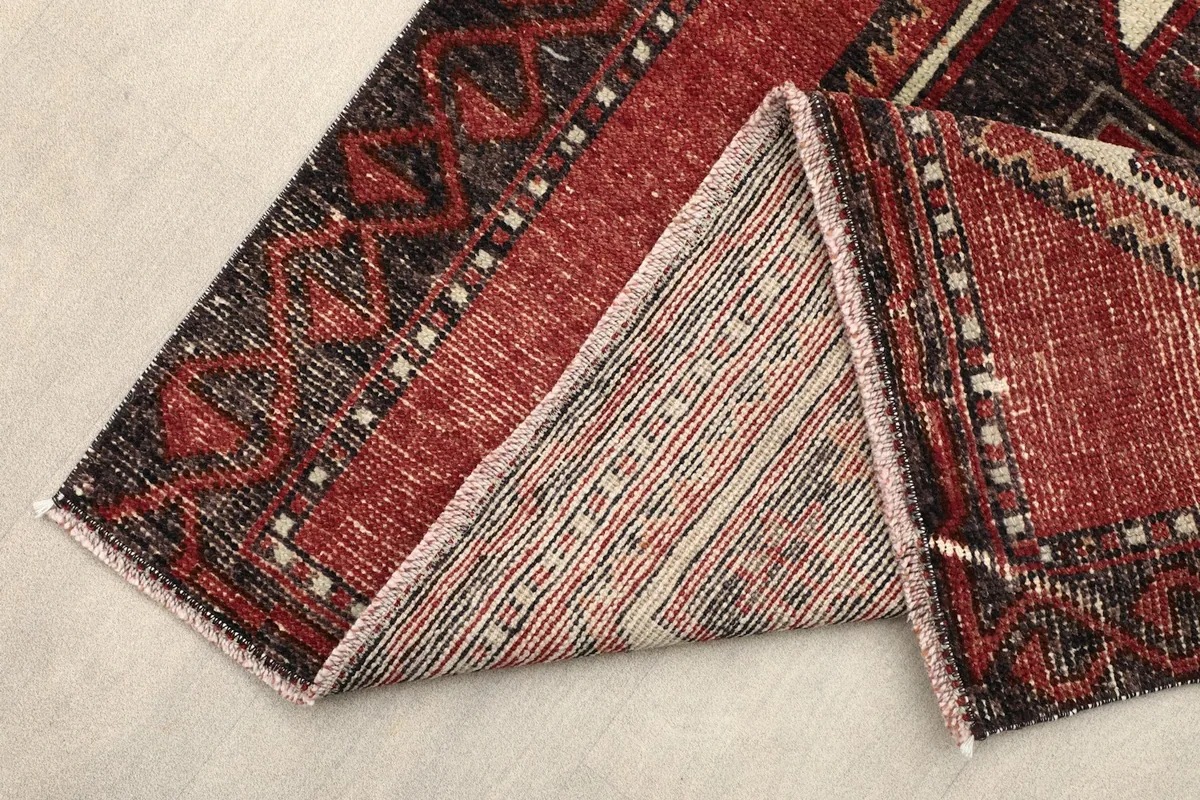 View of the back of the hand-knotted wool runner, showing the cotton foundation and knotting.