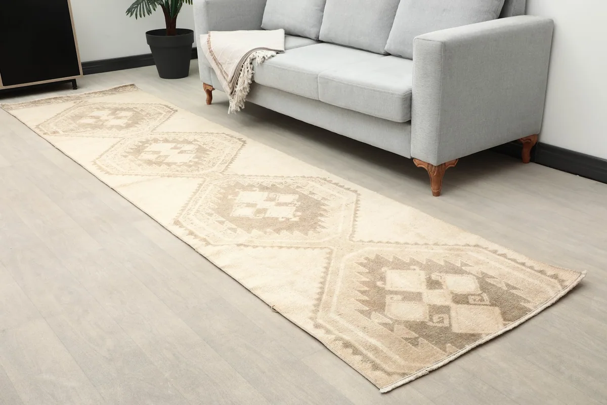 Full length view of the runner rug in a room, extending from the foreground towards a sofa