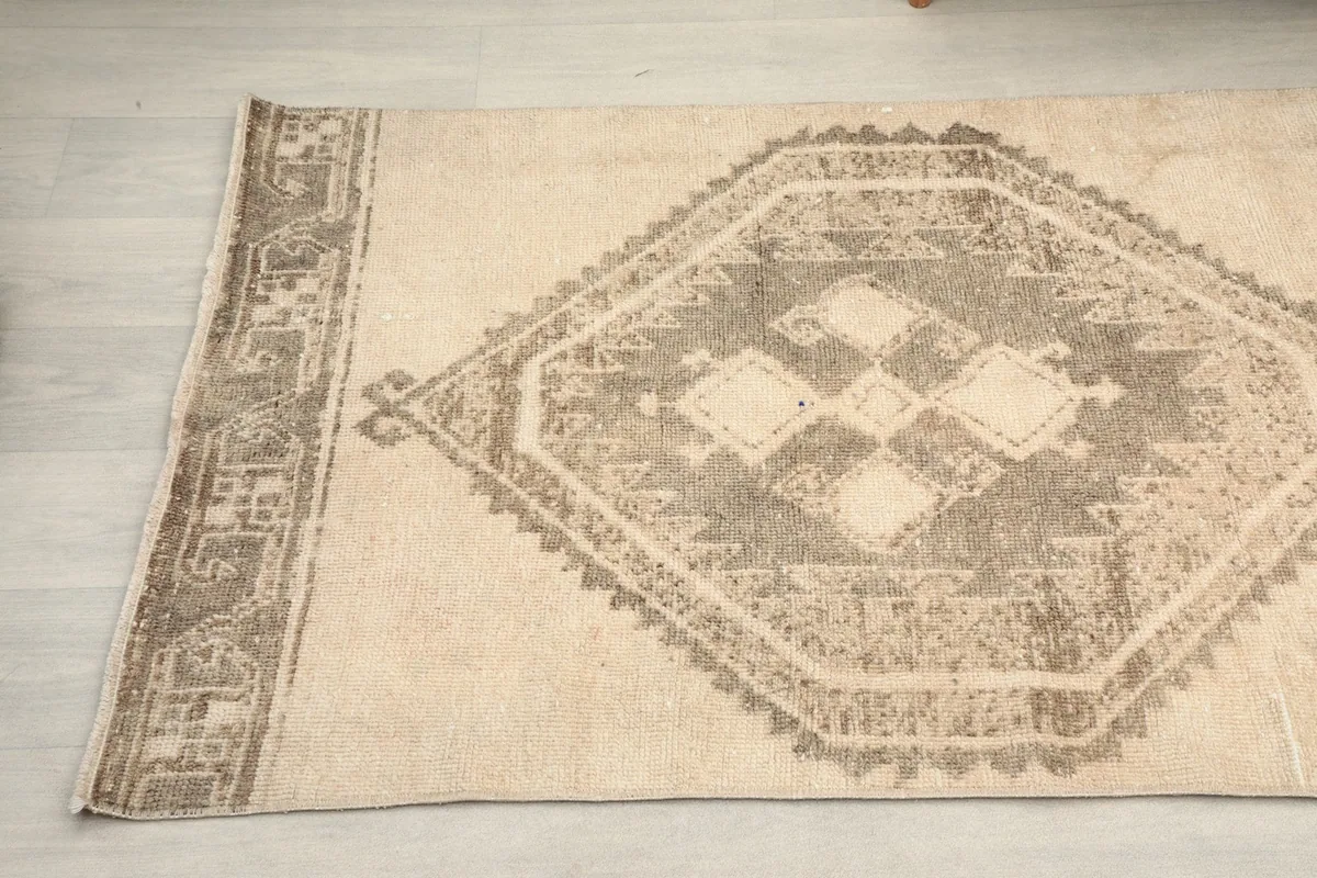 Detail view of the rug's side, showcasing the border design and the main tribal pattern