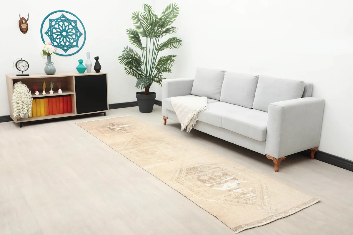 Long shot of the tan runner in a living space, showing its full length