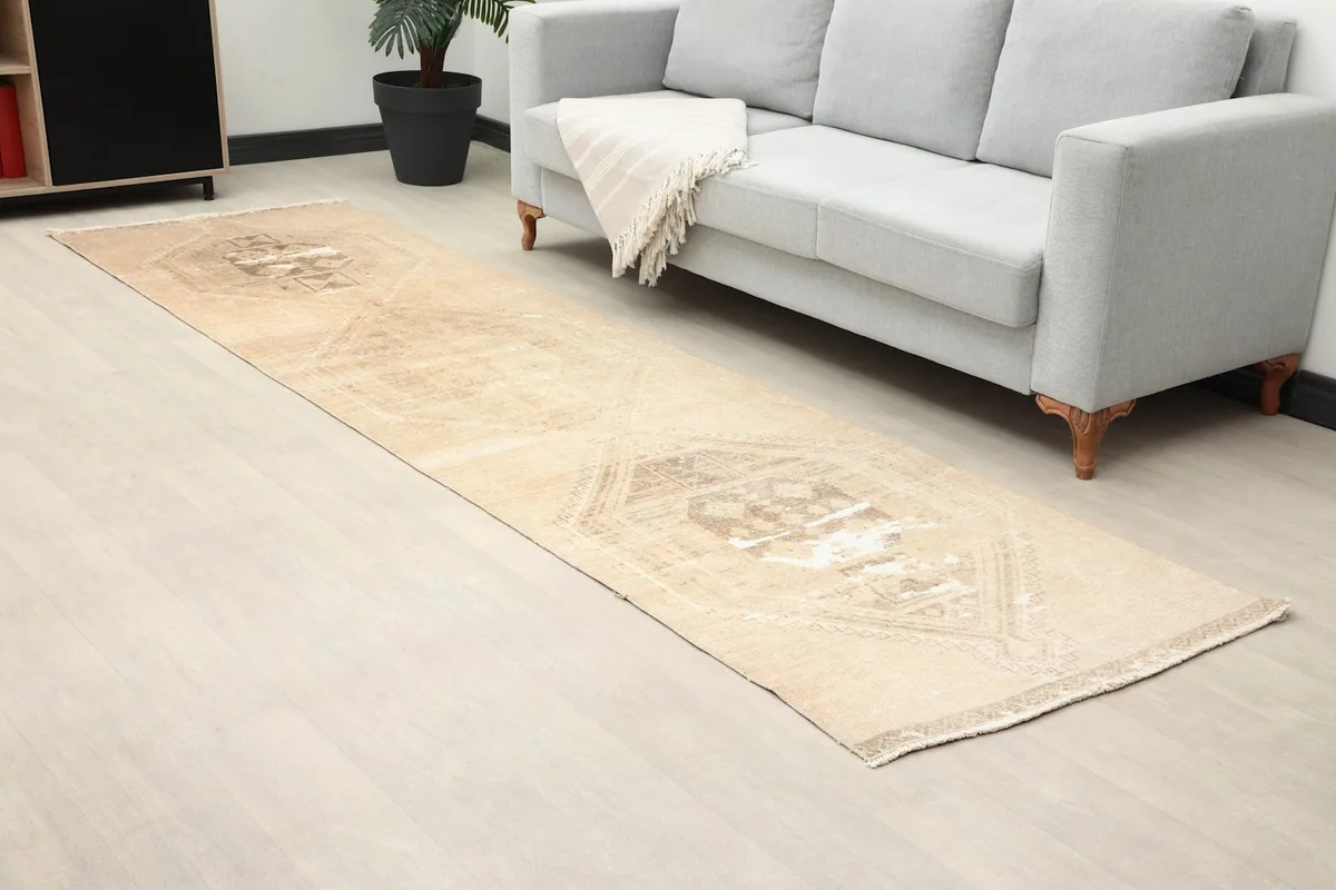 Closer room view highlighting the distressed areas and tan field of the runner