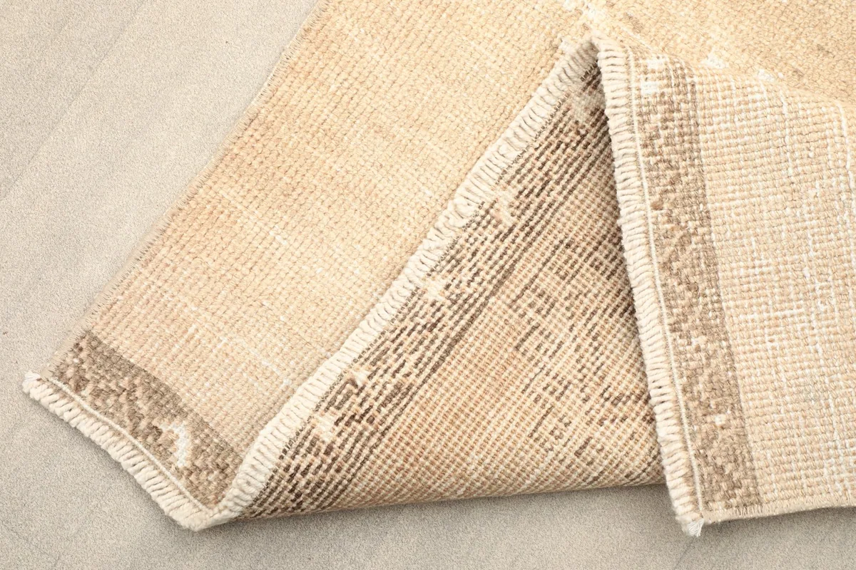 Corner of the runner folded to show the hand-knotted wool pile on cotton foundation