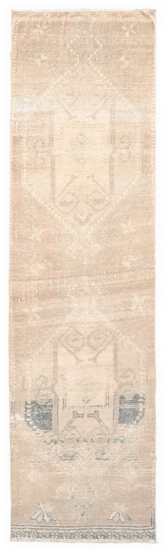 Full top view of the 2'7" x 9'4" beige tribal geometric runner rug on a white background.