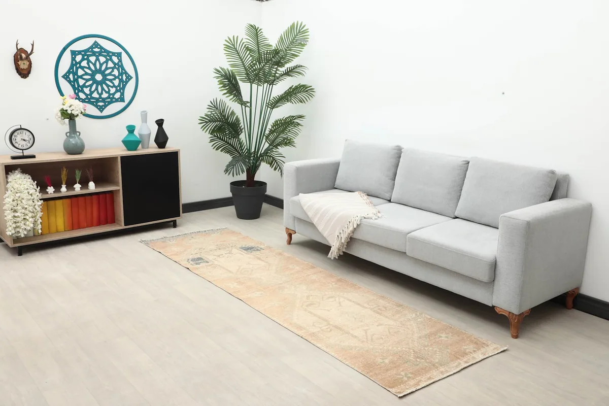 Runner rug displayed in a living room setting with a sofa and decor, showing its full length.