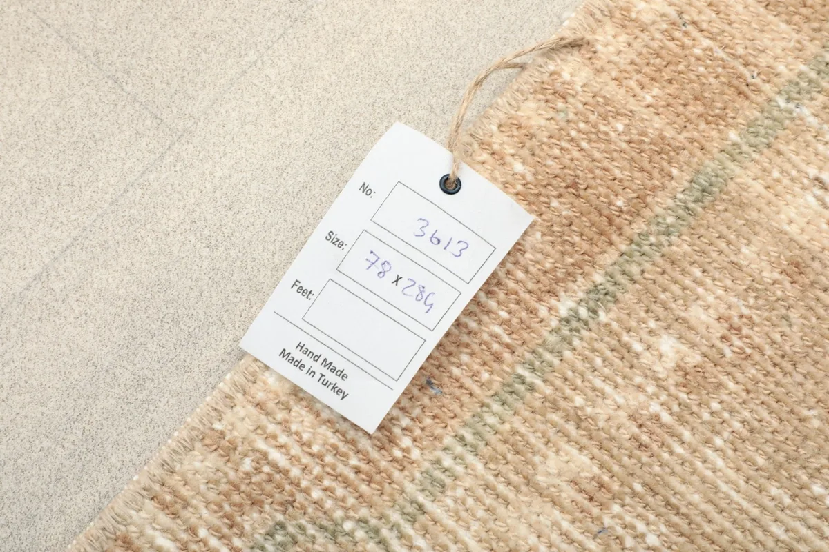 Product tag attached to the rug, displaying item number, size in centimeters, and 'Hand Made in Turkey'.